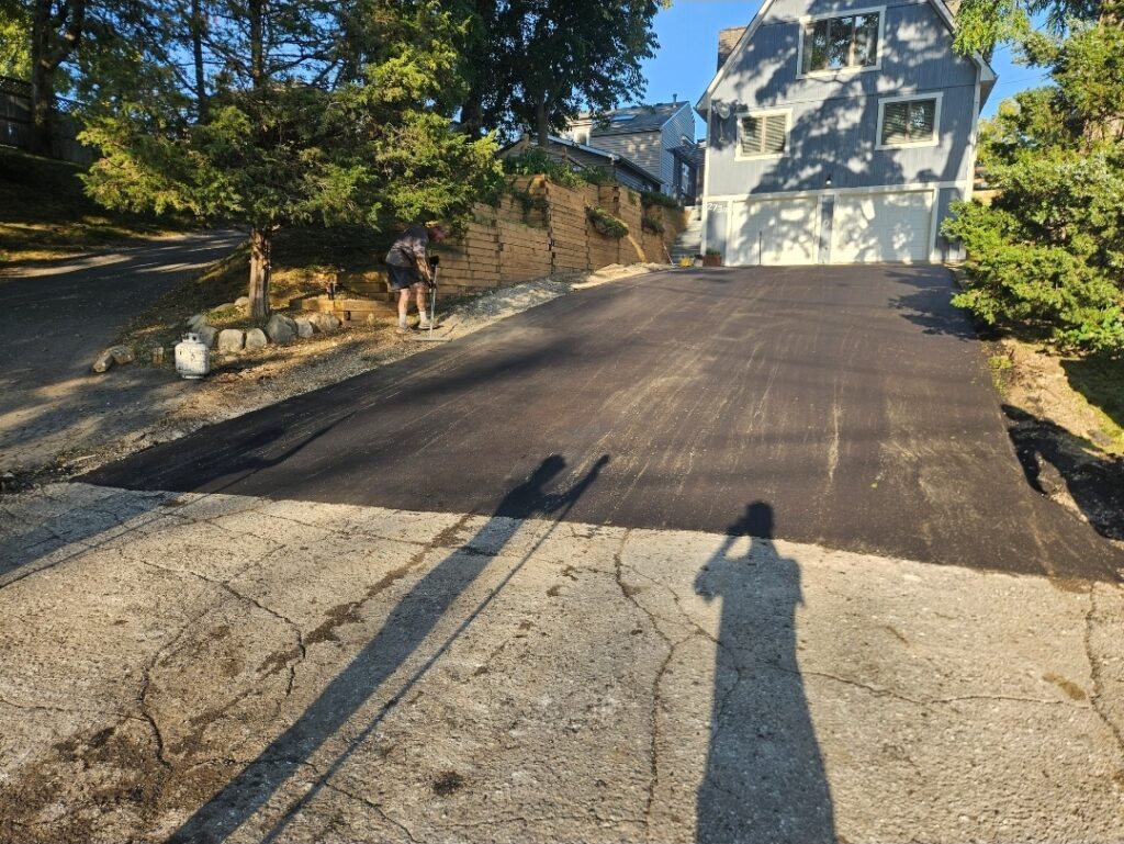 Residential asphalt driveway replacement and paving project.