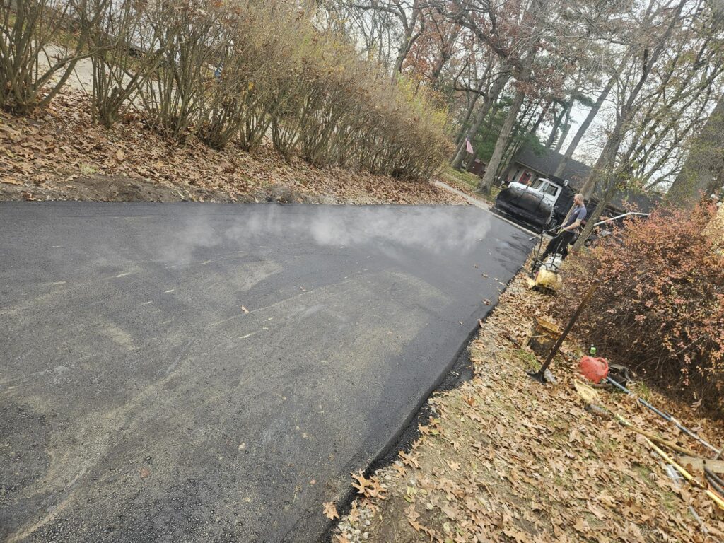 Residential asphalt driveway installed after grading and 21AA stone base preparation in Oakland County Michigan