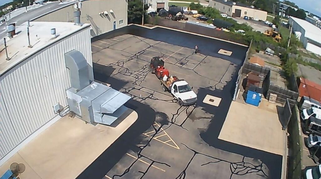 Commercial parking lot crack sealing and sealcoating preparation.