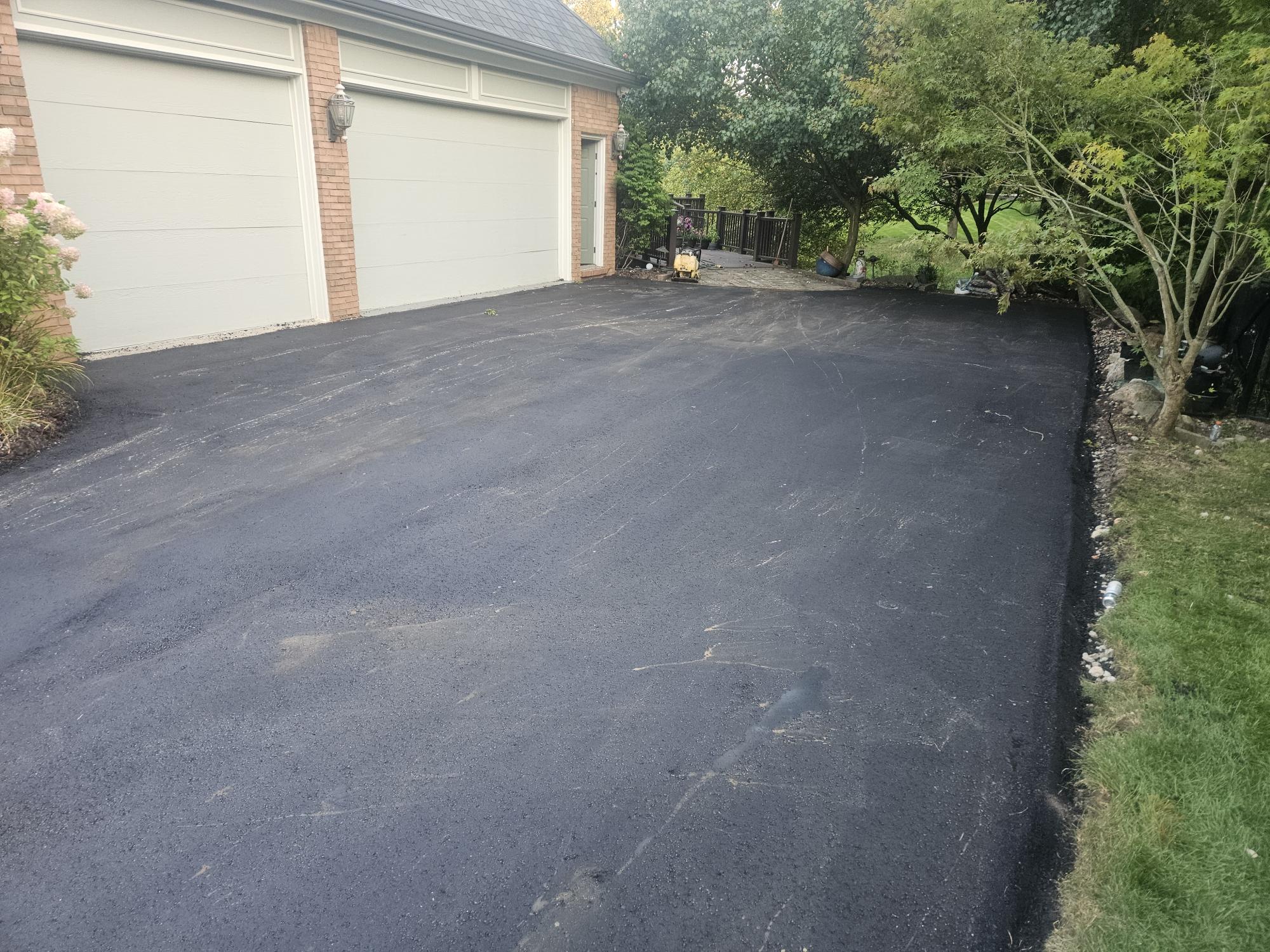 Residential asphalt driveway paving and replacement project.