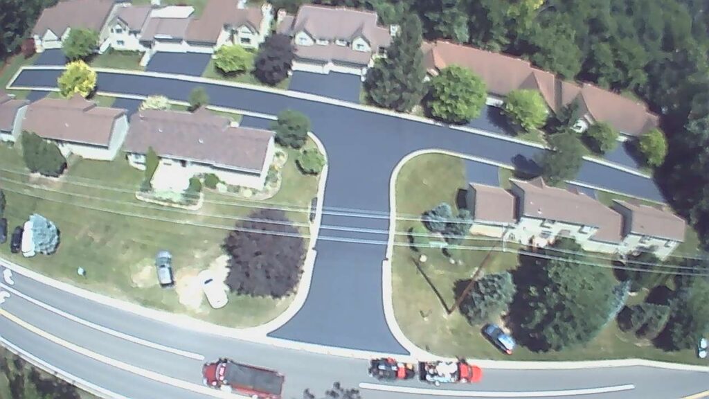 Residential neighborhood asphalt driveway sealcoating project.