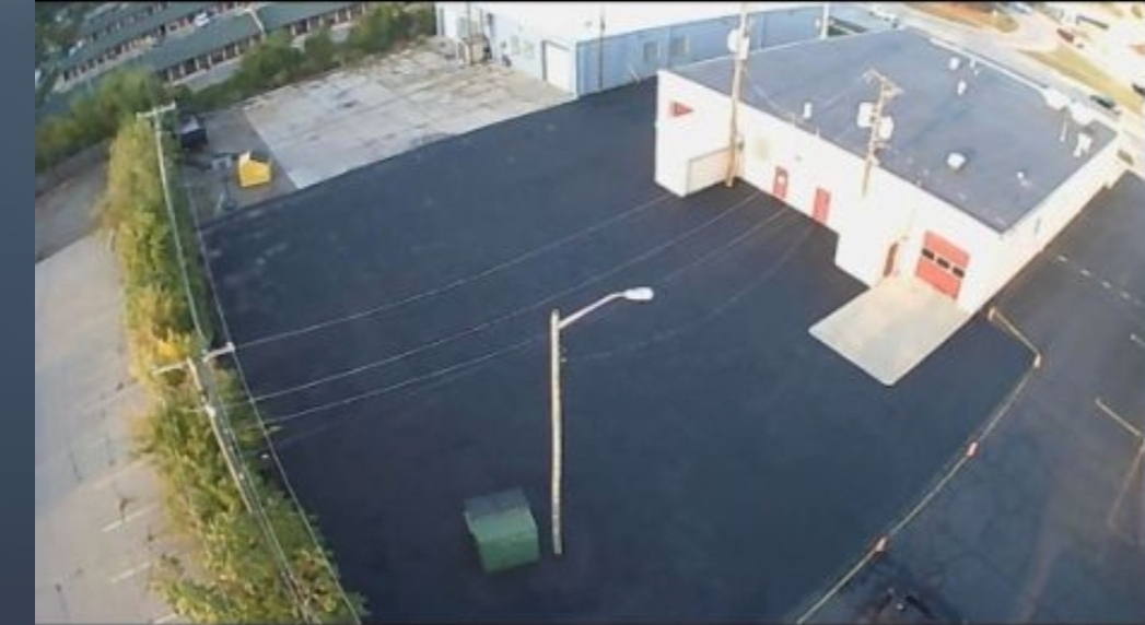 Large commercial asphalt paving project at industrial building.