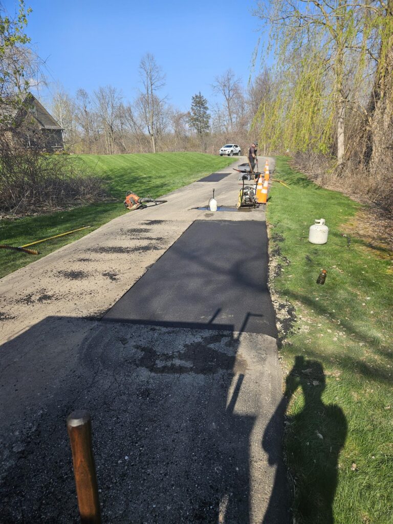 Residential asphalt patch repair on driveway.