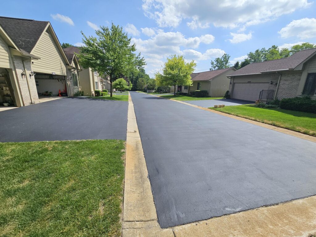 Freshly sealcoated residential asphalt roadway in neighborhood.
