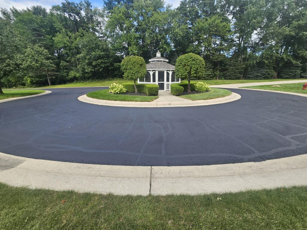 Sealcoated asphalt cul-de-sac driveway in residential neighborhood.