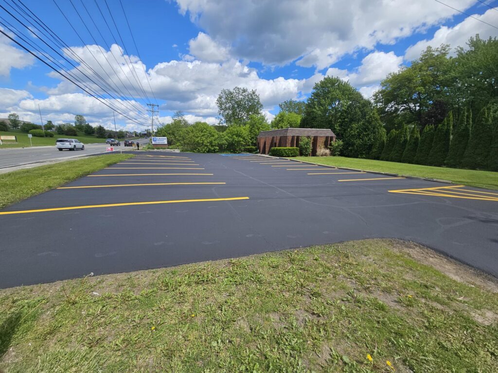 New asphalt parking lot with fresh striping at commercial property.